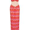 Colorful retro two-piece outfit with wavy pink, orange, and yellow pattern, featuring an off-shoulder crop top and matching skirt with cutout details