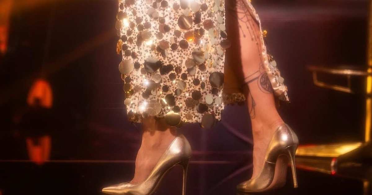 Sıla Gençoğlu wearing Uptown Luxe gold sequin dress by Nana Gotti during her European tour performance