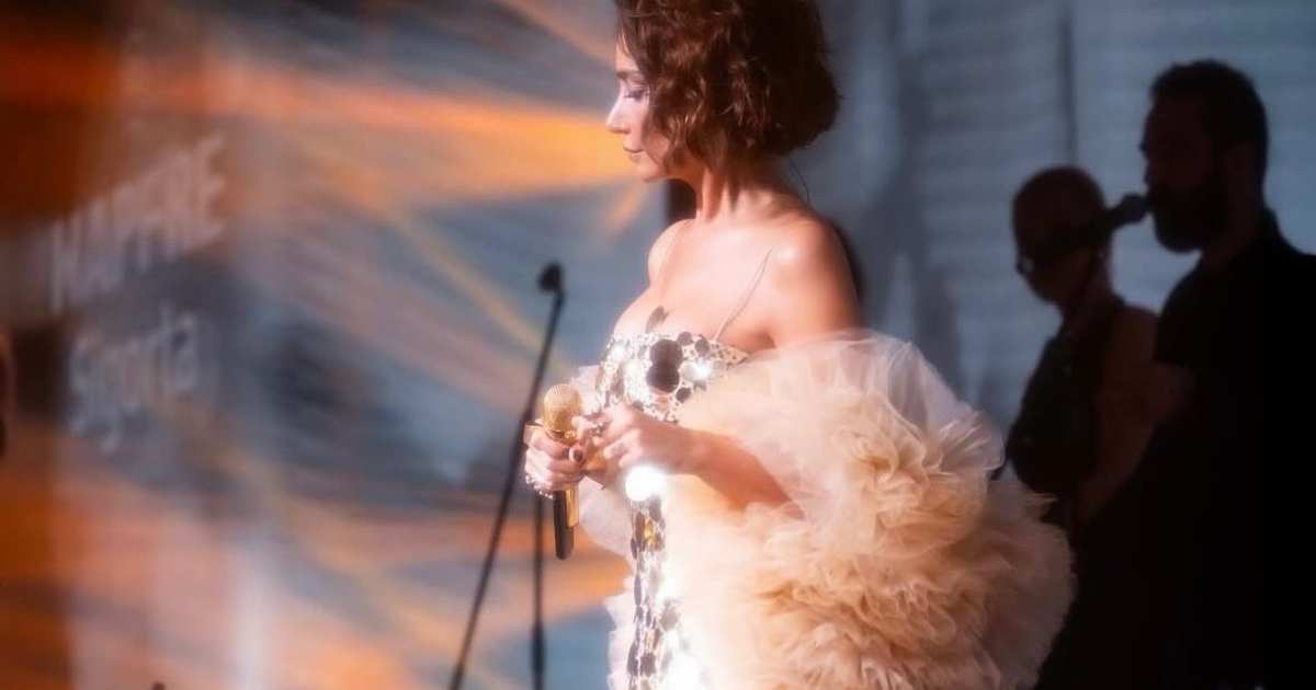 Sıla Gençoğlu wearing Uptown Luxe gold sequin dress by Nana Gotti during her European tour performance